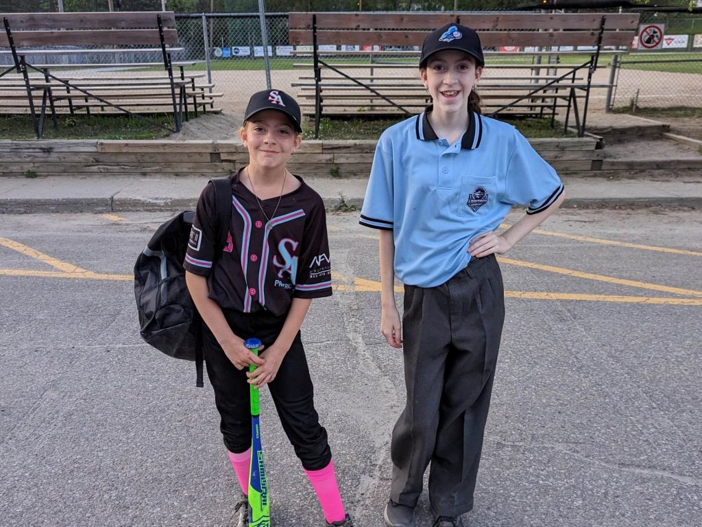 une joueuse et une arbitre sur un terrain de baseball